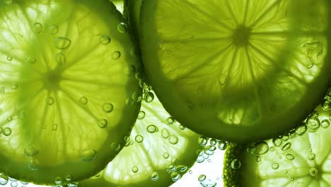 lime slices in water with bubbles