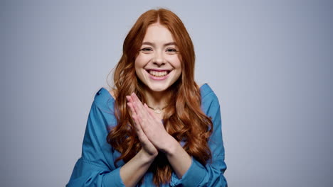 positive girl making hand gestures in studio. woman getting good news indoors