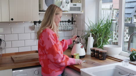 woman making tea in kitchen