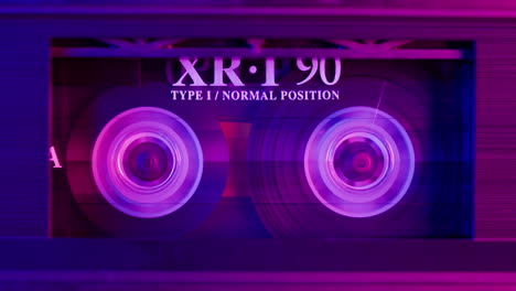 close-up of an audio cassette tape with neon lighting