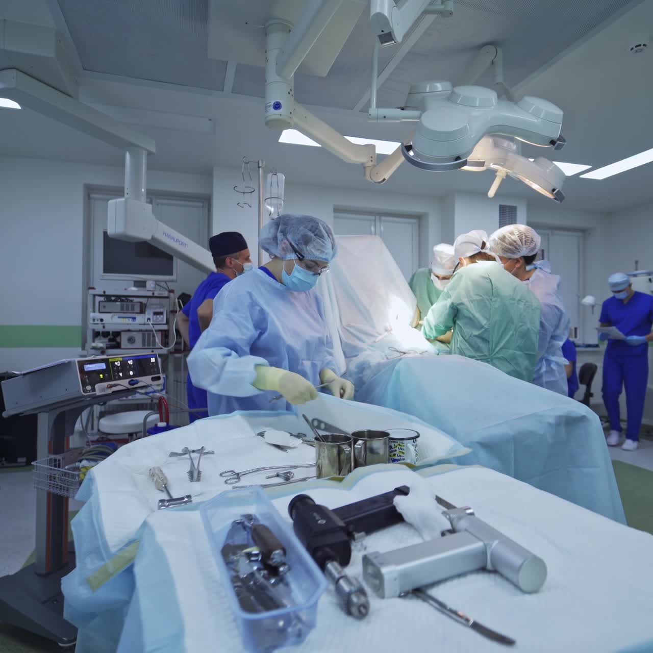 Group of surgeons working in emergency hospital room. Professional surgeons in modern ward