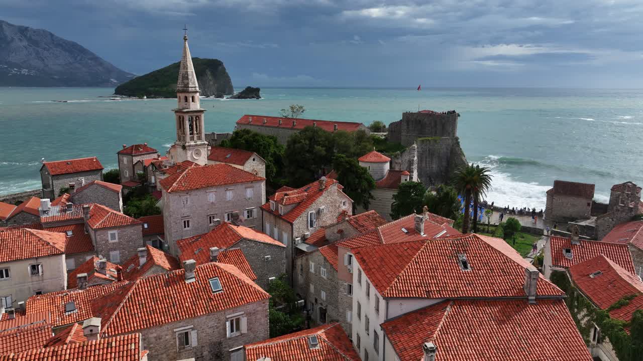 Budva Old Town, Bell Tower Of Church With Adriatic Sea In The Background In Montenegro. - aerial shot