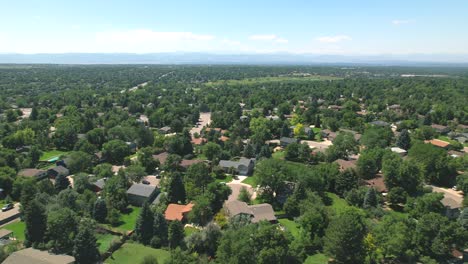 low drone flyover of houses in american suburb of denver colorado during the summer