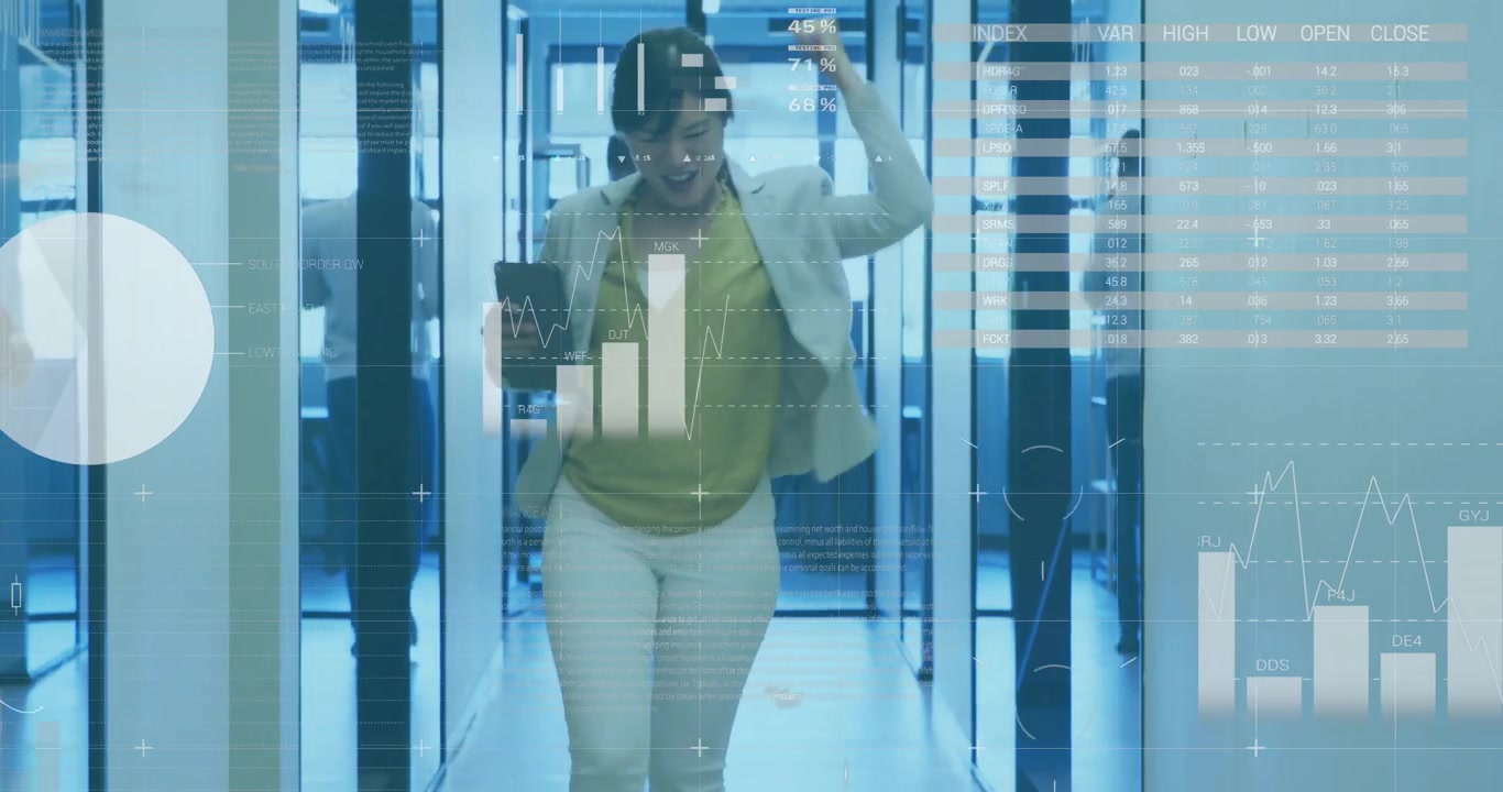 Three coworkers walking through tech office corridor, showing pie charts, bar graphs and world map