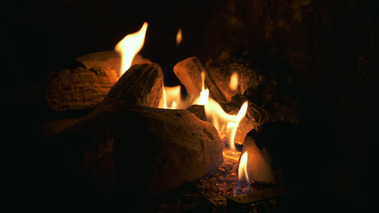 Fireplace. Fire. Dark in slow motion.