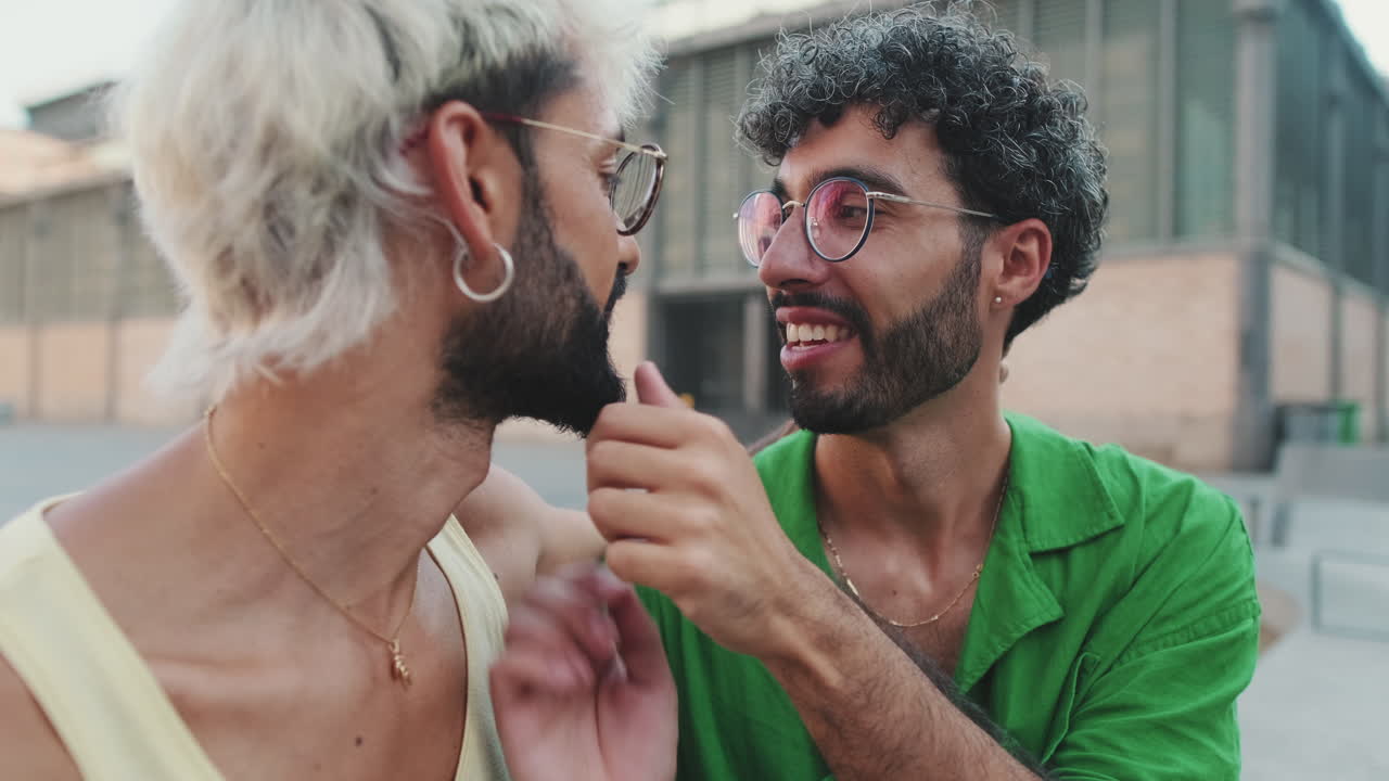 Affectionate Gay Couple Whispering and Smiling in Urban Setting