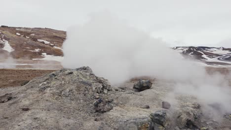 Man-suddenly-appear-from-white-dense-vapor-cloud-from-Icelandic-steam-vent