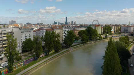 aerial establishing shot along danube canal in vienna, austria