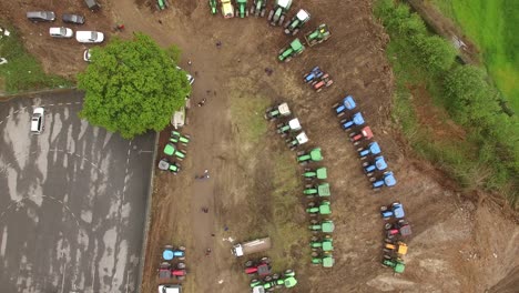 aerial top view of new truck tractor cars parking for sale stock lot row, dealer inventory import and export business commercial