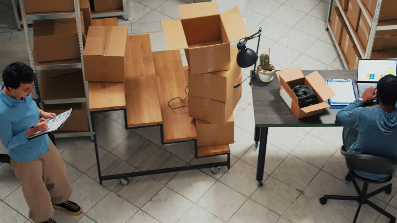 Warehouse scene with people working at desks and moving boxes