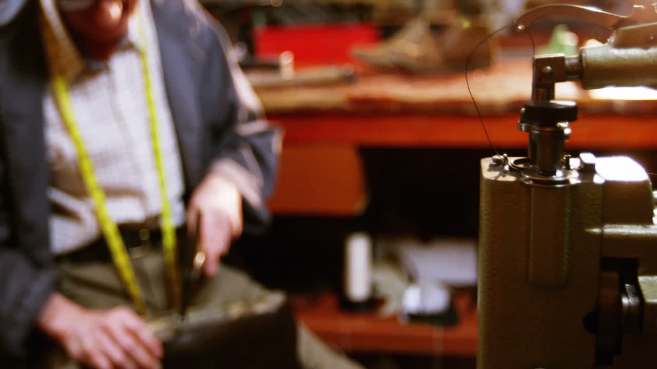 Shoemaker hammering on a shoe