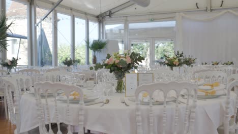 slow establishing shot of beautifully set tables ready for the wedding