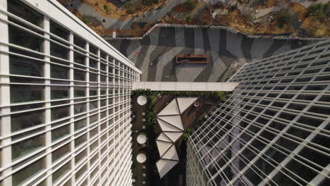 rising up between two new office buildings with a patio below