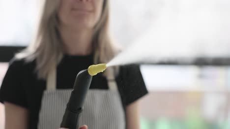 woman using a steam cleaner for household cleaning