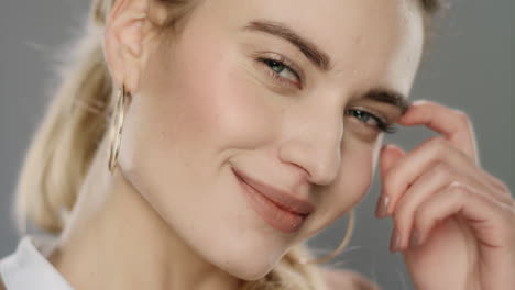 smiling woman portrait. playful woman smiling on gray background.