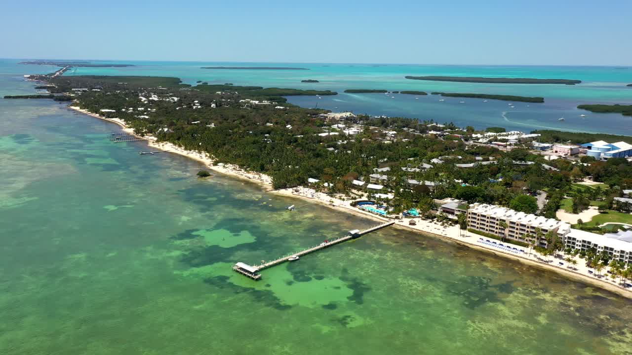 Aerial establishing of Florida Keys coastline showing turquoise water and beachfront road