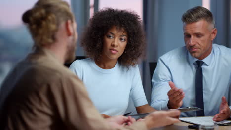 Mixed-race-businesswoman-and-businessman-convincing-partner-to-make-deal
