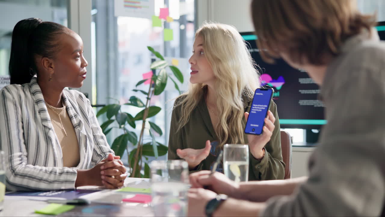 Business meeting with diverse team using smartphone for presentation