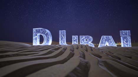 dubai desert at night with illuminated letters