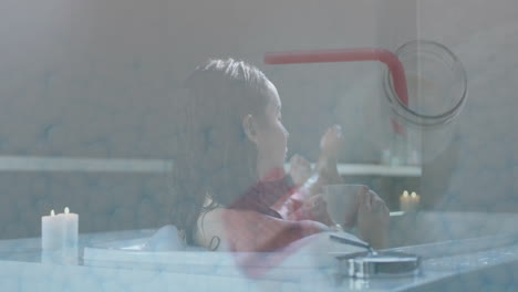relaxing in bathtub, woman drinking from cup with candlelight ambiance