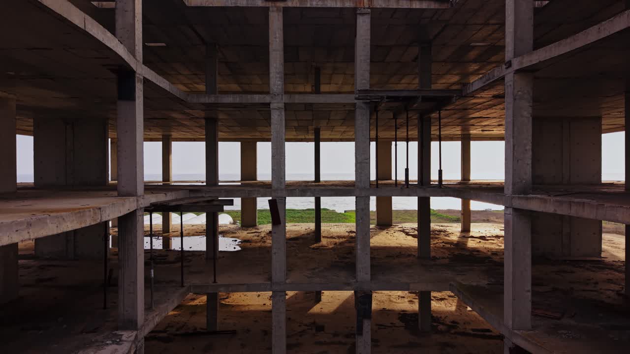 Construction site seen from above with concrete structure and landscape