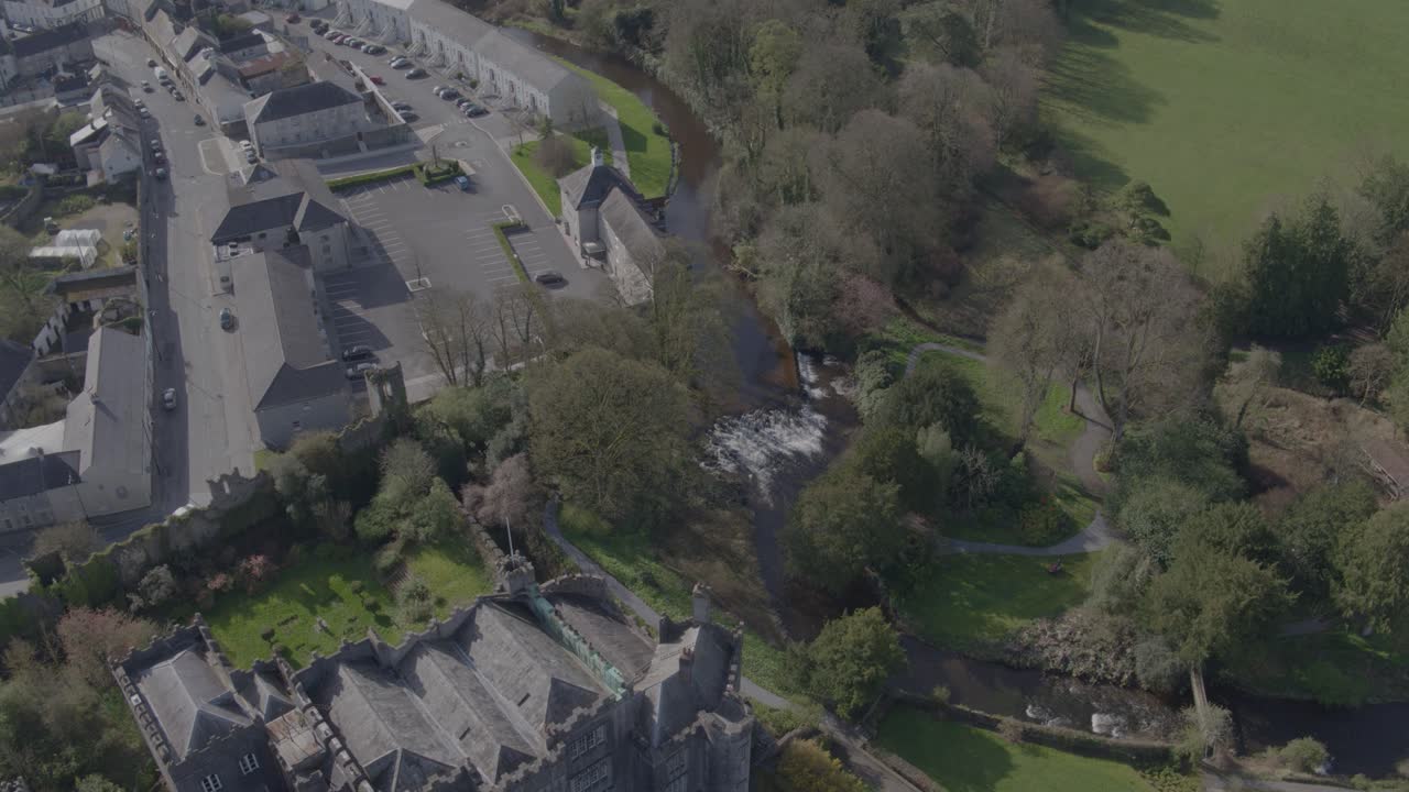 A flyover shot from a drone that goes directly over Birr Castle in Birr, Co. Offaly and briefly showcases the town, trees and lake behind it