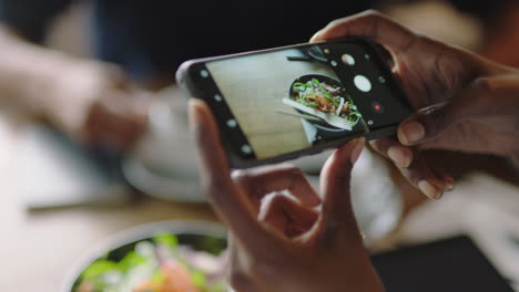 business woman in cafe using smartphone taking photo of healthy salad sharing vegetarian lifestyle on social media enjoying relaxing restaurant close up hands