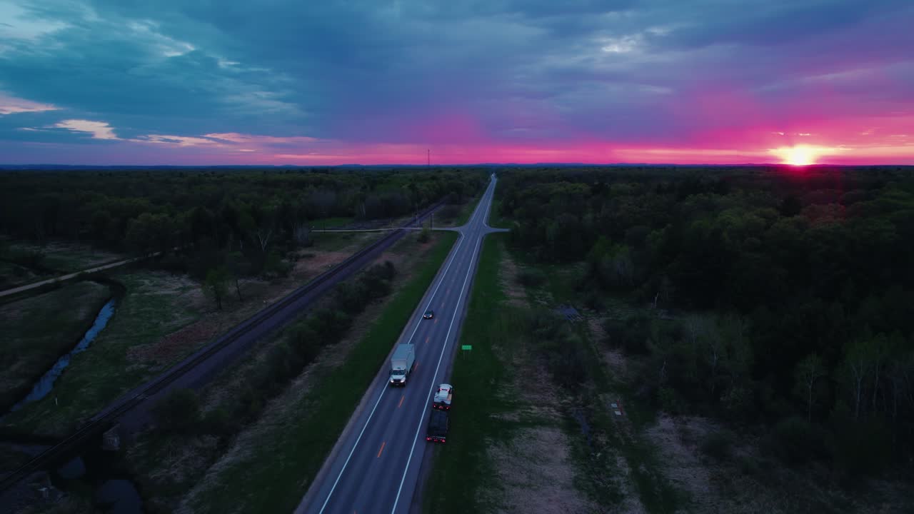 Sunset Drone Aerial of Semi-Truck on Forest-Lined Highway in Wisconsin