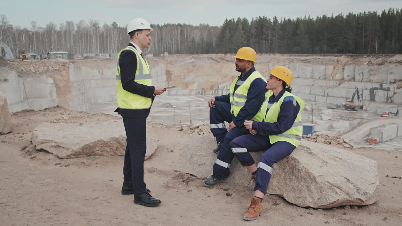 Manager Talking to Workers by Quarry