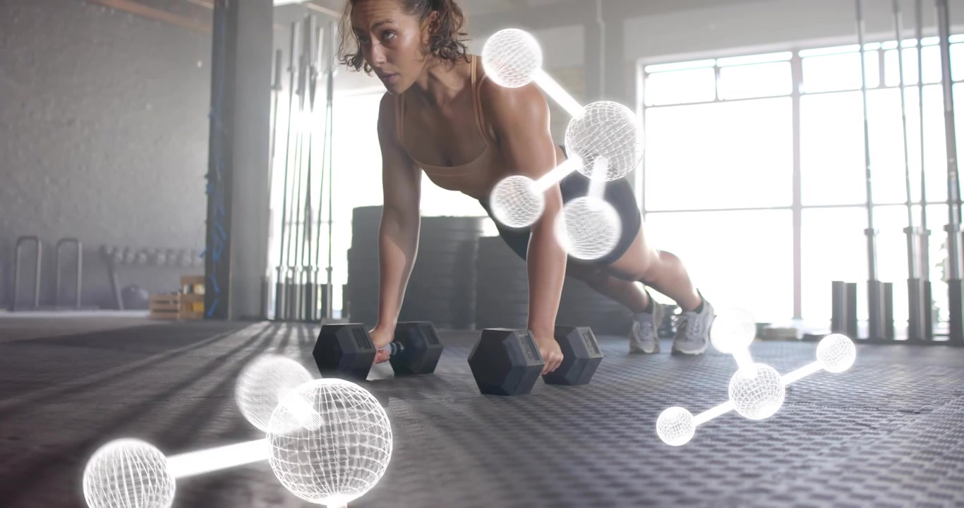 Woman gripping hex dumbbells and performing push-up reps in gym activating molecular graphics