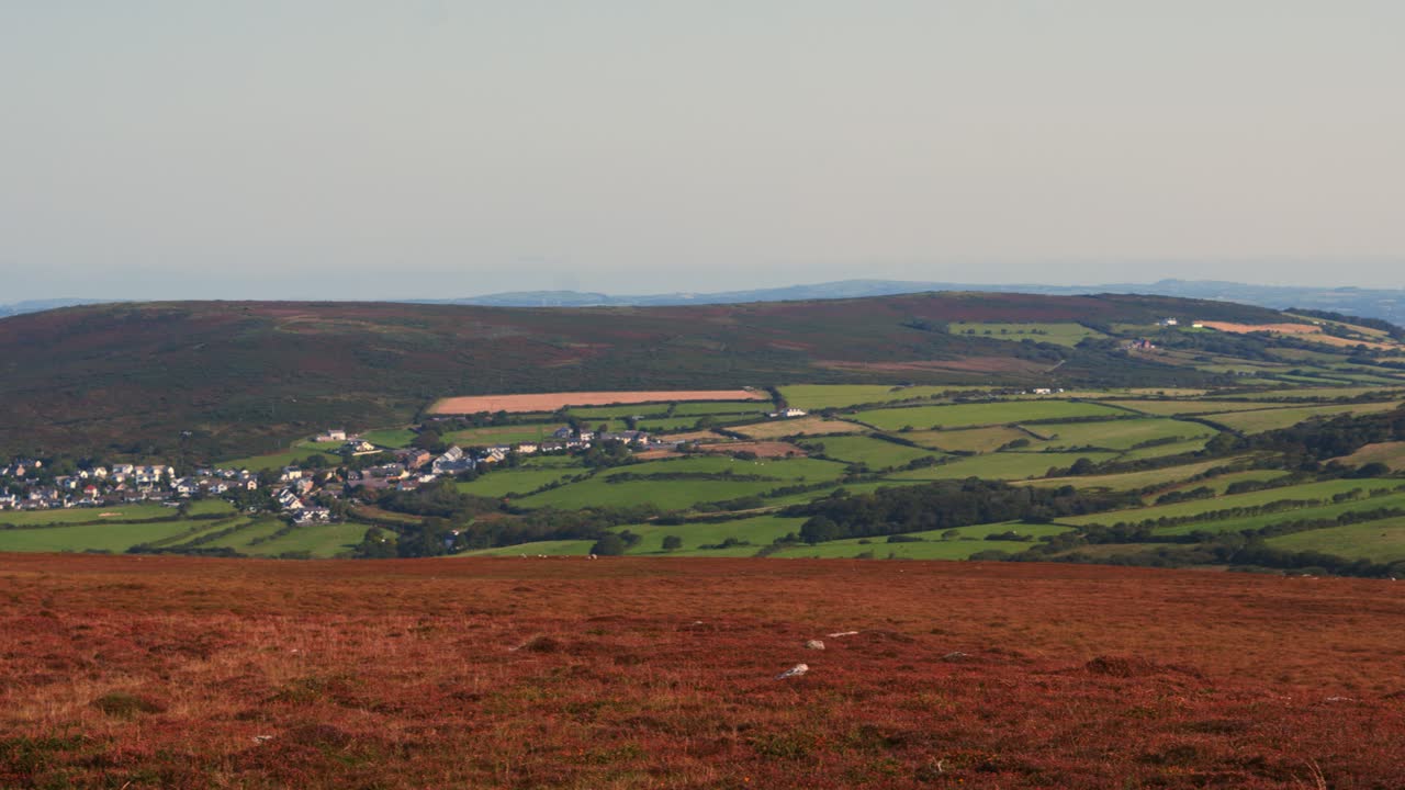 Camera Pan Across Welsh British Countryside Landscape with Moorland Foreground and Llangenith Rural Village with Farmed Fields and Loughor Estuary in Distance 4K