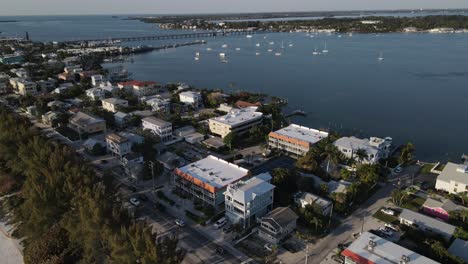 aerial-turning-to-reveal-the-docked-yachts-in-the-channel-in-Bradenton,-Florida-near-Cortez-Beach