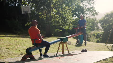 senior men enjoying a seesaw in the park