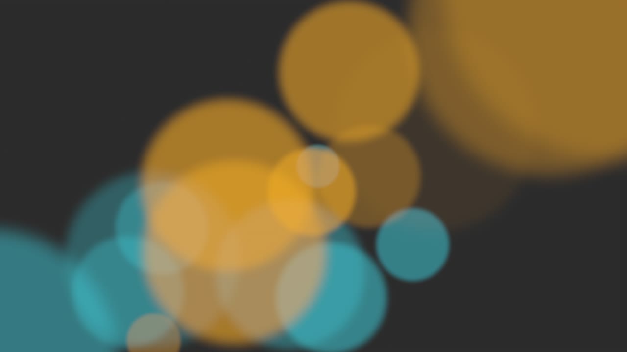 Yellow and blue big particles and round bokeh on dark background