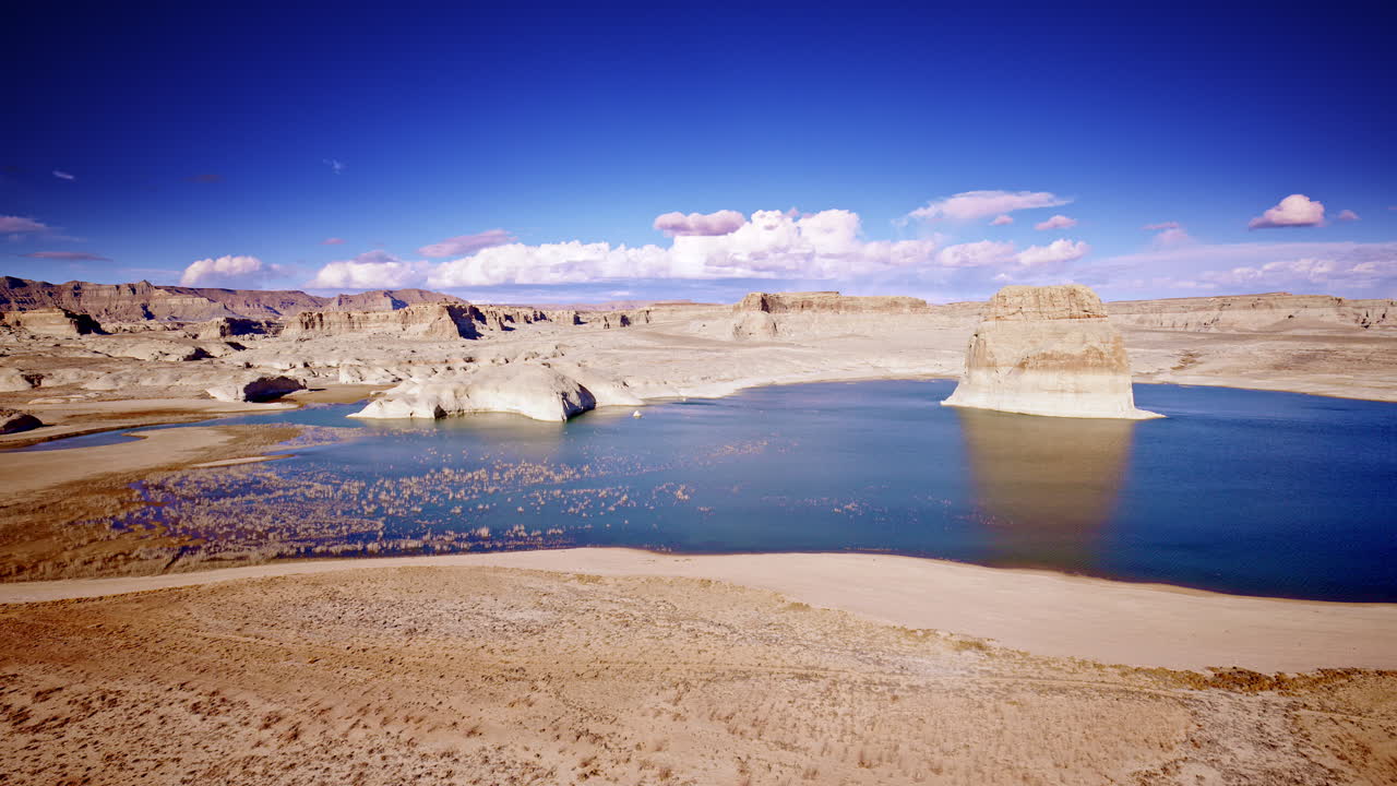 Drone shot flying towards interesting rock formations near Lake powell in Page Arizona