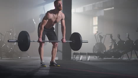 slow motion: male powerlifter preparing for training in gym. screaming man lifting weights