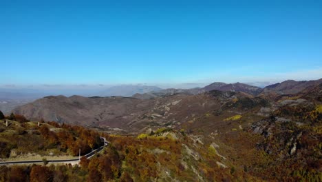 Colorful-landscape-with-mountains-and-yellow-brown-foliage-and-blue-sky-on-road-to-Dardha,-Albania