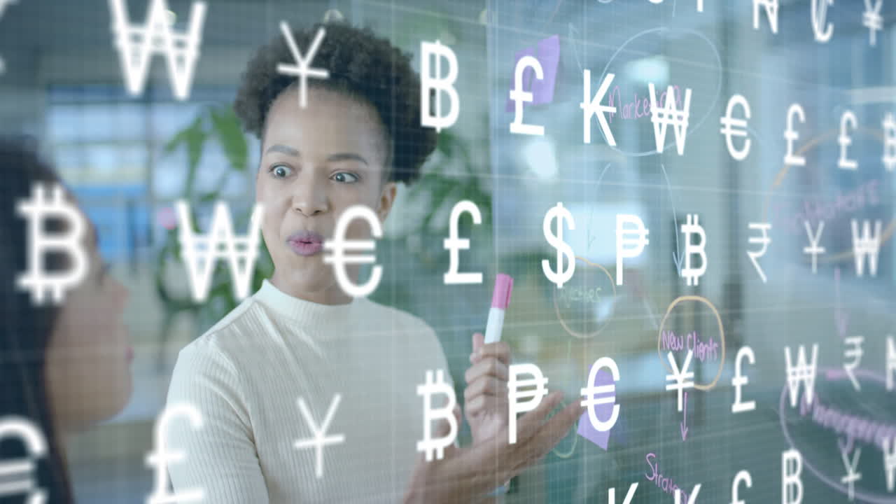 Animation of international currency symbols over diverse female colleagues brainstorming at office