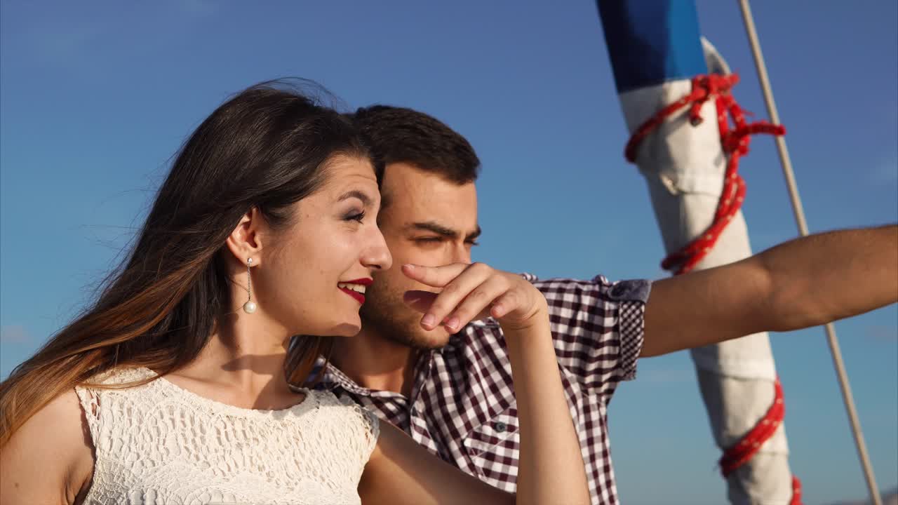 Couple enjoying the view from a sailboat