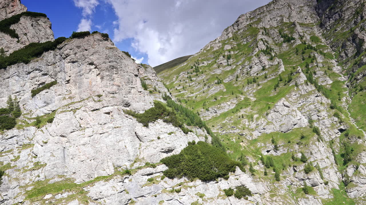 Grey cliffs with some scarce plants growing on. Travelling on the cable car in Busteni, Romania