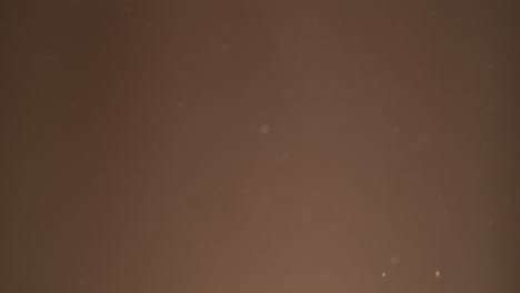 floating dust particles on brown background