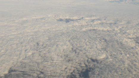 aerial view of clouds out of plane window shot in 4k high resolution