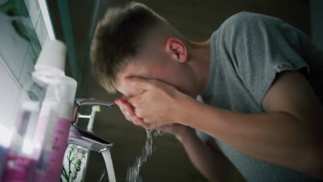 teenager washing hands in bathroom