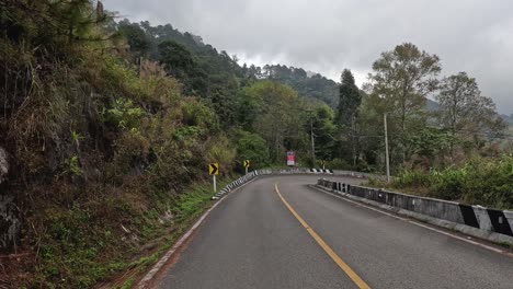 car travels along a winding mountain road