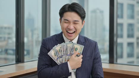happy businessman holding money