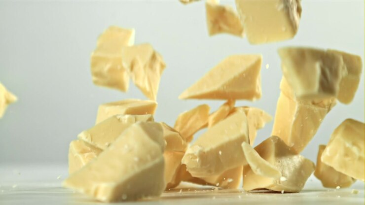 White Chocolate Chunks Falling in Slow Motion on a White Background