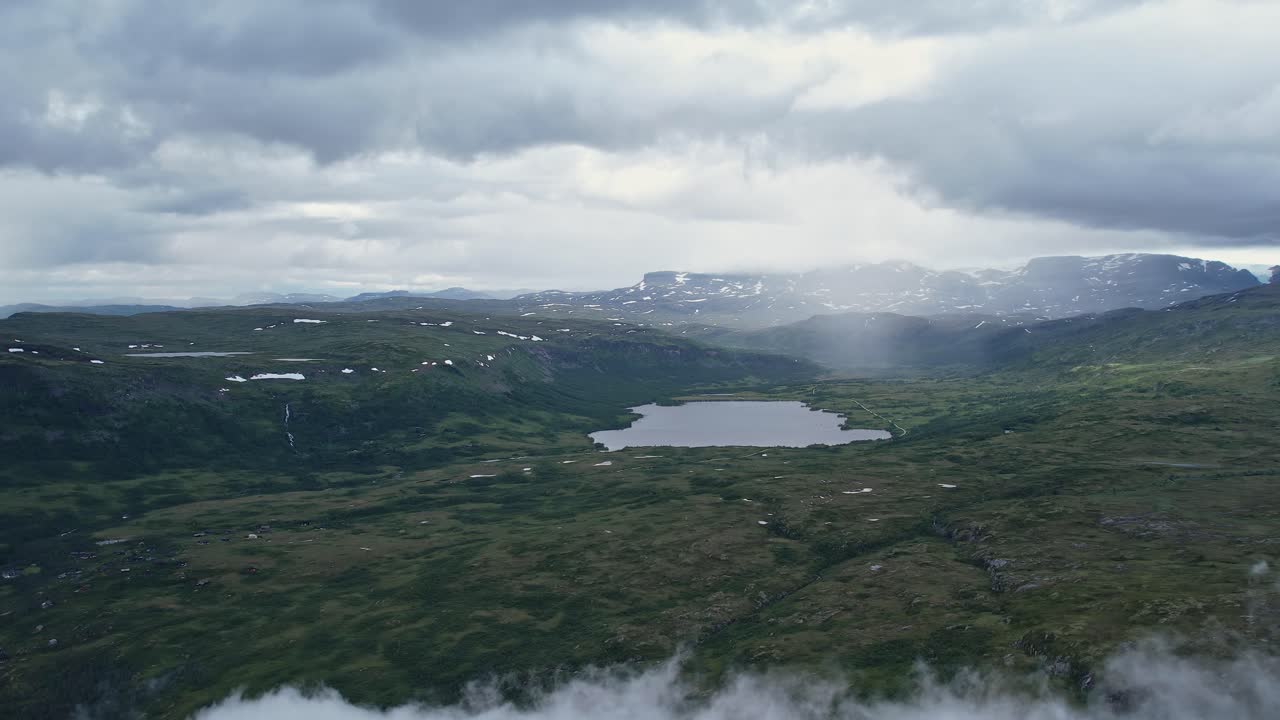 Stunning aerial view of Norway's serene landscape with lake and mountains