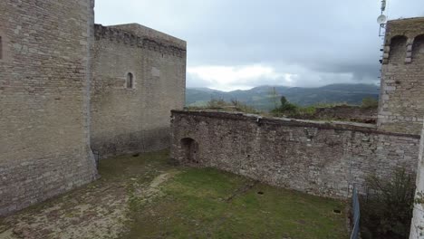 inside a courtyard of rocca maggiore castle fortress in assisi, italy