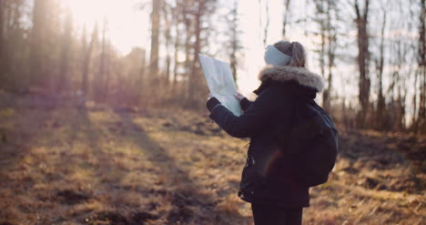 tourist reading map on trail in mountains 12