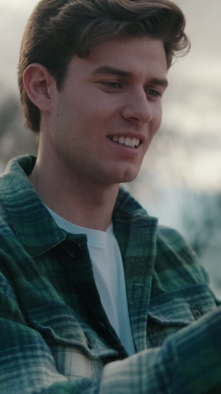 Young man taking photo on mobile phone